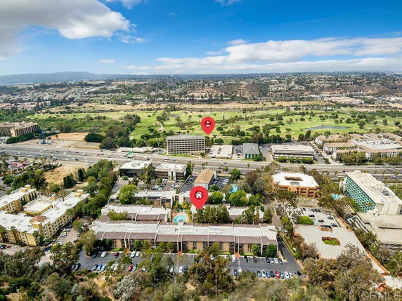 Wide-angle aerial view of urban area with buildings and greenery.