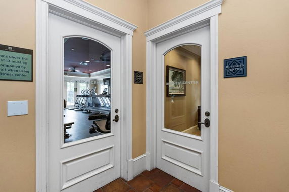Interior view showing doors to a fitness center and a business center.