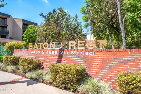 Front view of a building with a brick sign that reads 'Eaton Crest' and the address 4499 & 4589 Via Marisol.