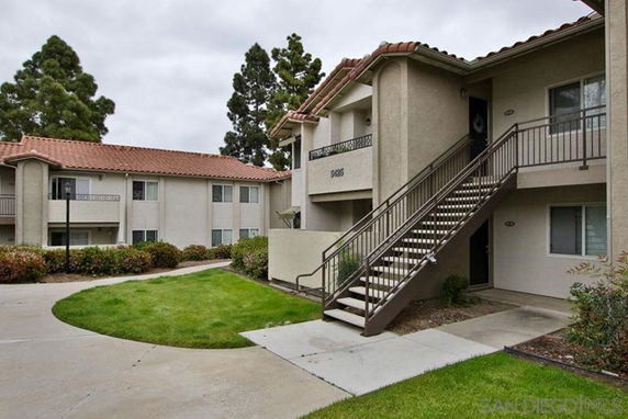 Front view of an apartment building with external staircases.