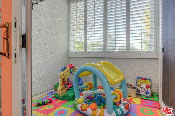 Indoor play area with toys and a small slide