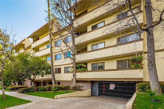 Front view of a multi-story residential building with balconies.