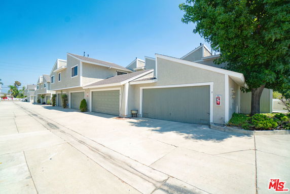 Front view of a two-story townhouse with attached garages.