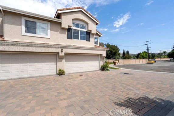 Front view of a two-story house with three garage doors.