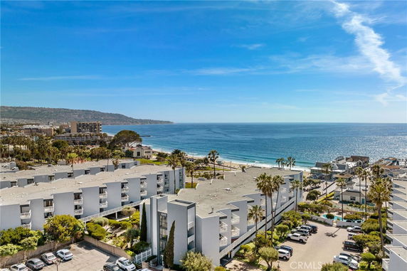 Wide-angle view of beachfront residential buildings and the ocean.