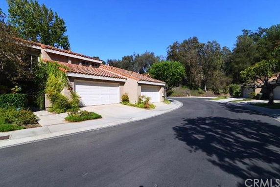Front view of houses with double garages on a curved street.