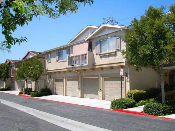 Front view of a multi-unit residential building with garages.