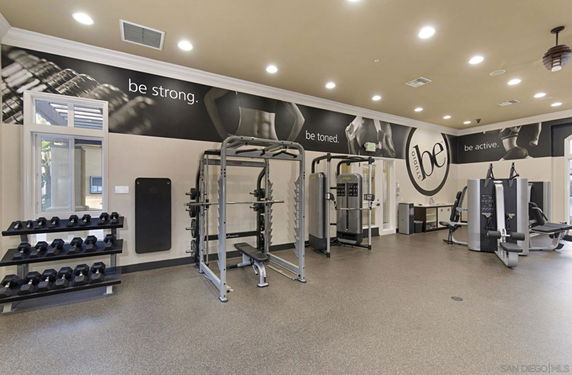 Indoor gym area with exercise equipment and motivational wall art.