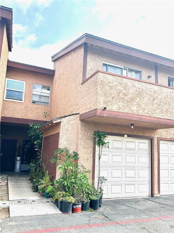 Front view of a two-story townhouse with a garage.