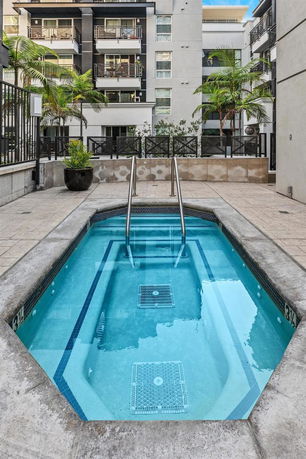 Outdoor communal swimming pool area in a residential building