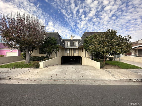 Front view of a two-story house with an integrated garage space.