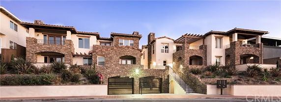 Front view of a multi-story building with stone and stucco exterior.