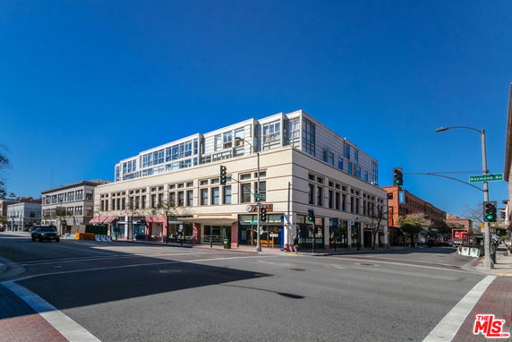 Front view of a multi-story commercial building on a street corner.