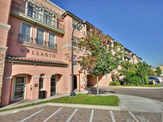 Front view of a multi-story residential building with a sign that reads 'VILLAGIO'.