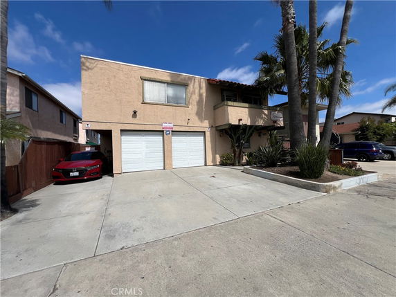 Front view of a two-story building with a double garage.