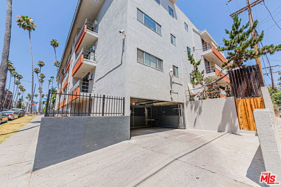 Front view of a multi-story apartment building with balconies.