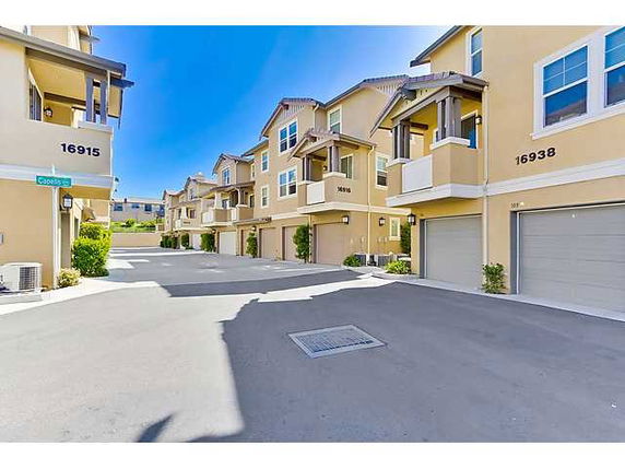 Front view of townhouses with garages in a residential complex.