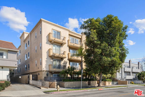 Front view of a multi-story residential building with balconies.