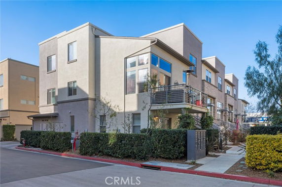 Front view of a multi-story house with modern design and balcony.