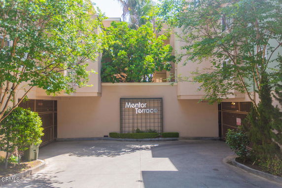 Front view of a multi-story building entrance with a sign reading 'Mentor Terrace'.