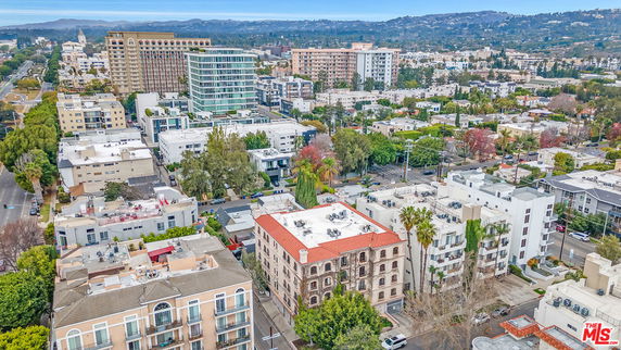 Panoramic view of a cityscape with multiple buildings and trees.
