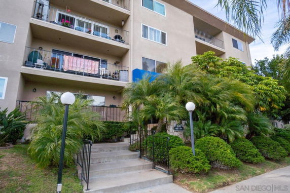Front view of a multi-story residential building with balconies.