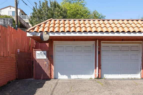 Front view of a garage with two doors and a terracotta tiled roof.
