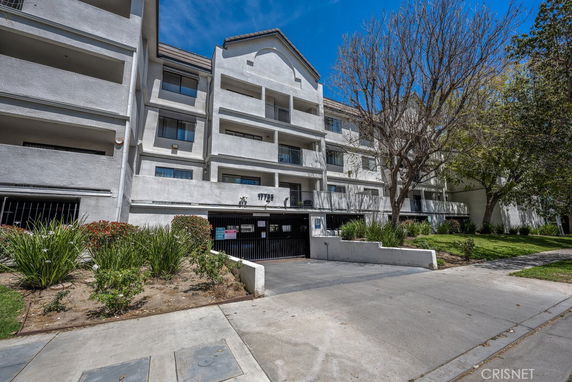 Front view of a multi-story apartment building with balconies.