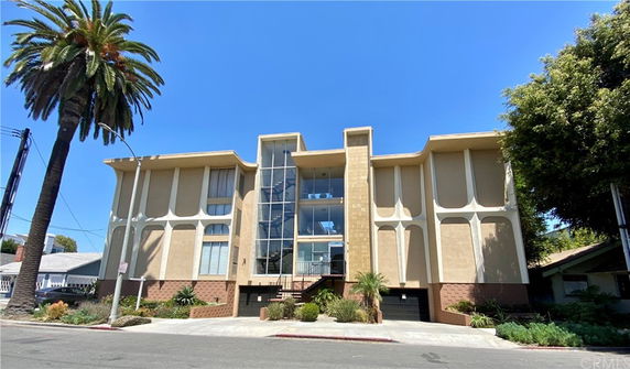 Front view of a multi-story building with a modern facade and large windows.