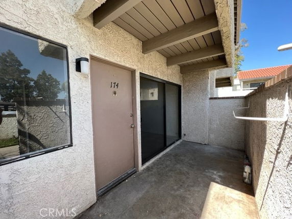 Front view of a building entrance with a covered porch area.