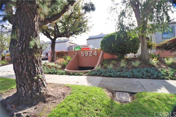 Street view of building with address number 5924, partially obscured by trees and shrubs.
