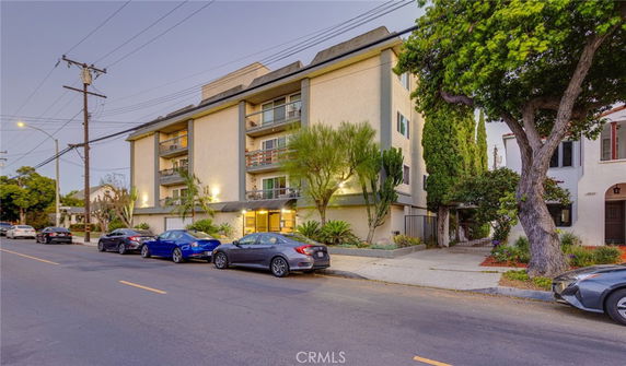 Front view of a multi-story apartment building with balconies.