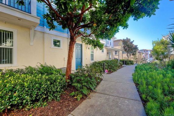 Front view of a house with a blue door and pathway