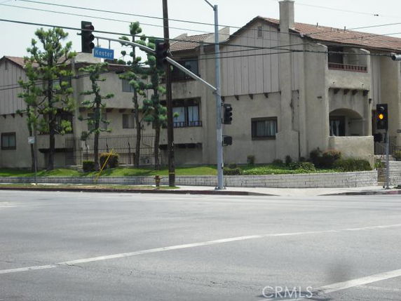 Front view of a multi-story building at a street intersection.