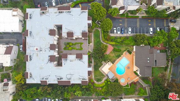 Aerial view of a large building complex with a swimming pool.
