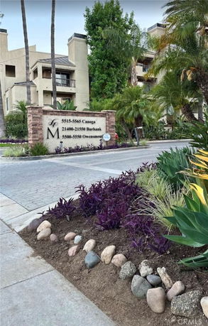 Front view of a multi-story building with adjacent landscaping.