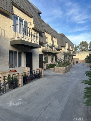 Front view of a multi-story residential building with balconies.
