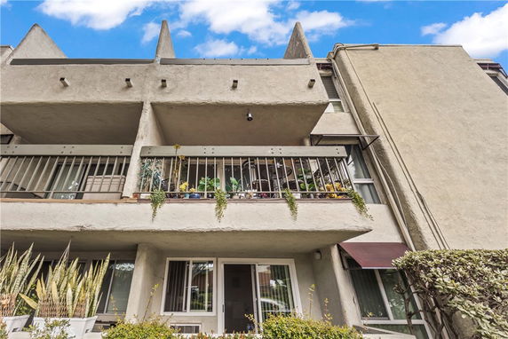 Front view of a multi-story building with balconies.