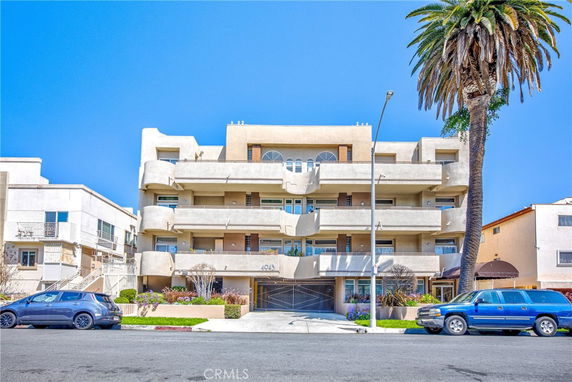 Front view of a multi-story apartment building with balconies.