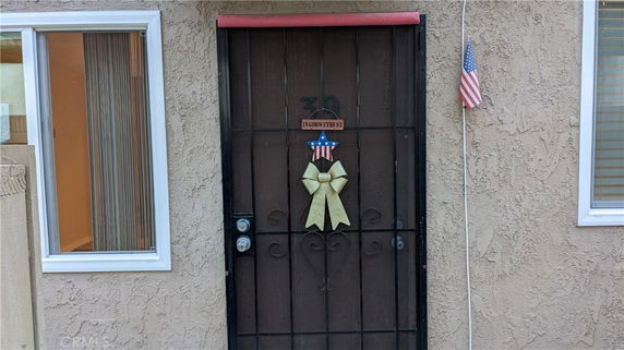 Front view of a house entrance with an American flag decor.