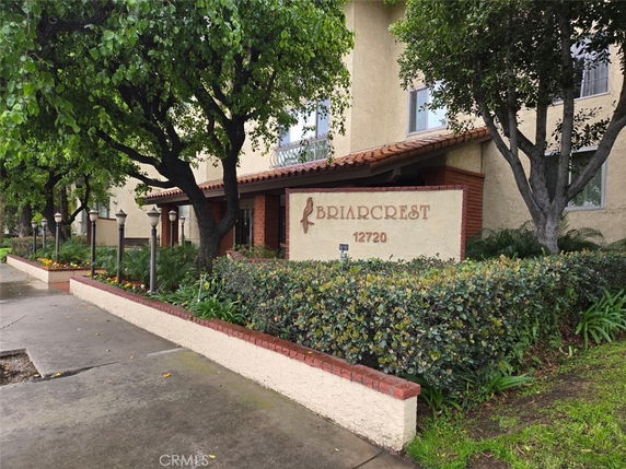 Front view of a building labeled 'BRIARCREST' with a tiled roof and surrounding greenery.
