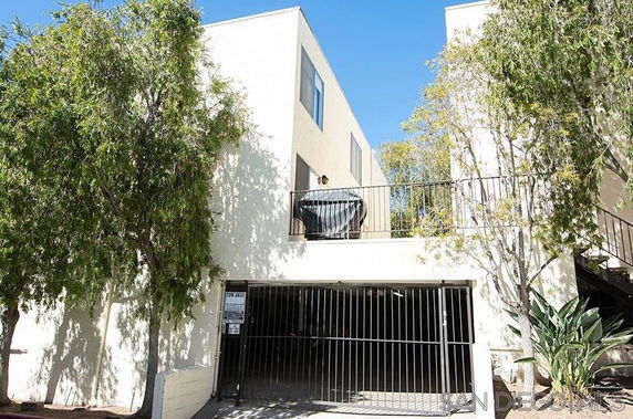 Front view of a two-story building with a gated entry.