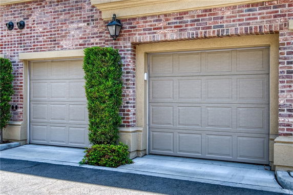 Front view of a house with double garage doors and brick exterior.