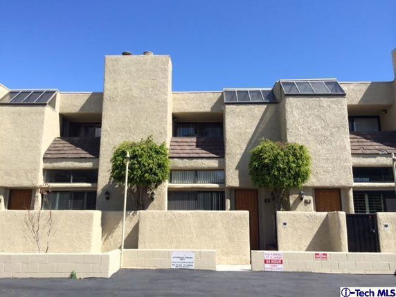 Front view of a multi-story building with modern architectural design.