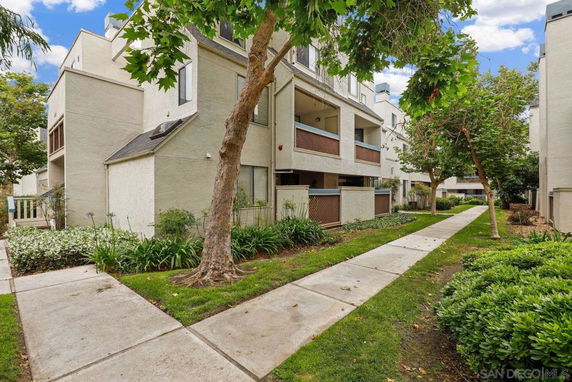 Front view of a multi-story residential building with balconies.