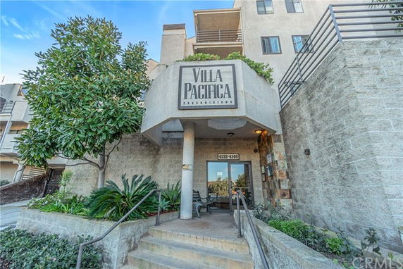 Front view of a multi-story residential building with a covered entrance.