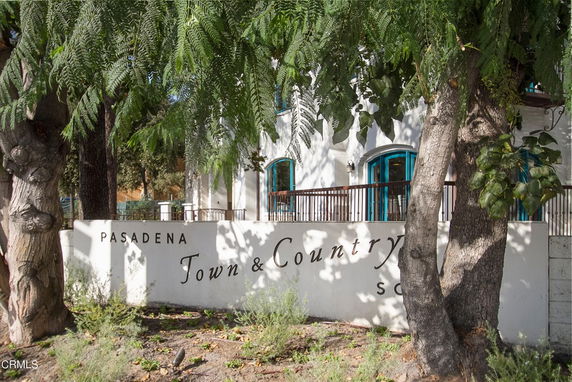 Front view of a building with a sign reading 'Pasadena Town & Country School'.