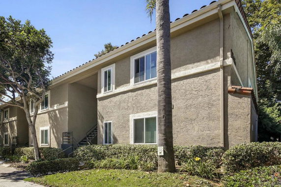 Front view of a two-story building with multiple windows and a textured exterior.