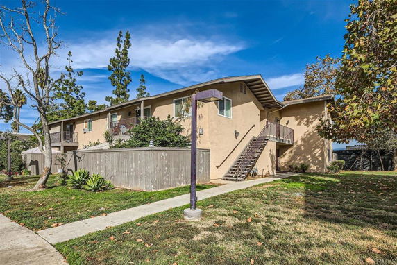 Front view of a two-story apartment building with external staircases.
