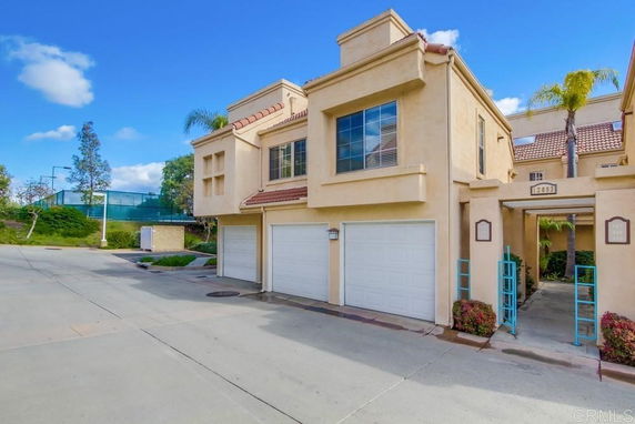 Front view of a multi-story house with double garage.